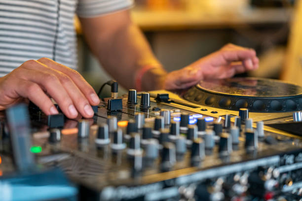 istock DJ Hands creating and regulating music on dj console mixer in concert 2187921226