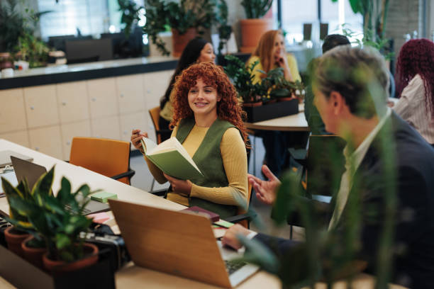 istock Managers discussing business strategy in modern green office 2187921926