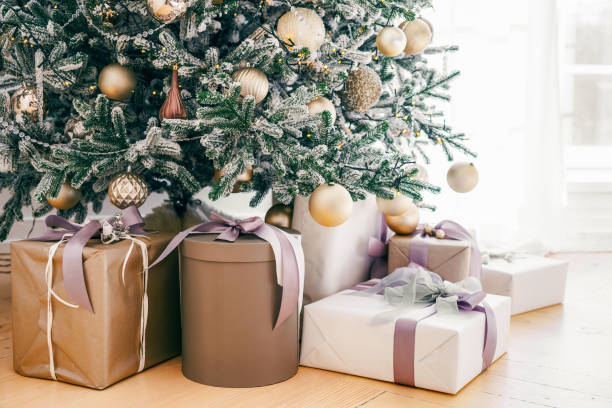 istock Decorated Christmas tree with frosted branches and wrapped presents, gift boxes it in living room 2187925134