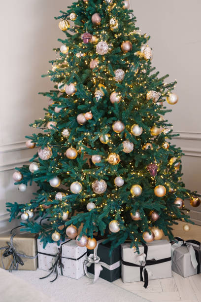 istock Decorated Christmas tree with presents in a cozy indoor setting during holiday season 2187925151