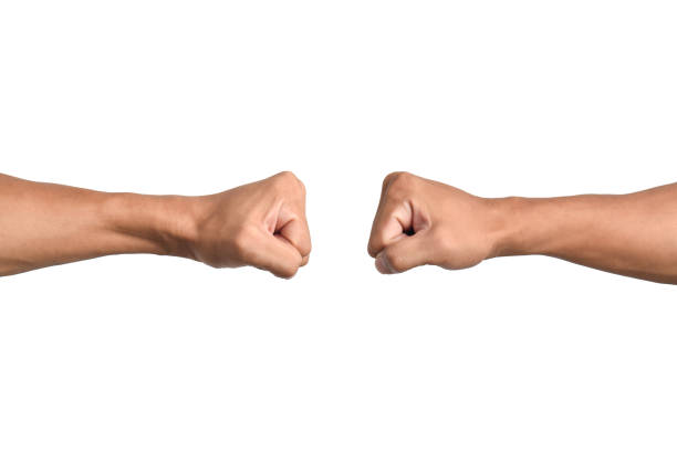 Clash of two fists isolated on White background. Concept of confrontation