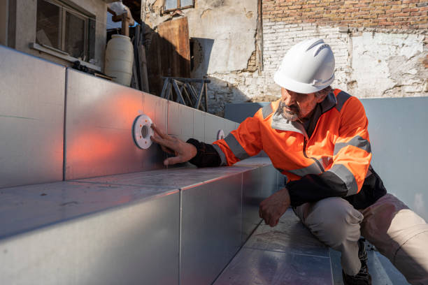Engineer Inspects Swimming Pool Structure on Construction Site Male engineer in safety gear and hardhat is closely inspecting large metal swimming pool structure on construction site during the building process. pool builders stock pictures, royalty-free photos & images