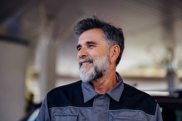 Smiling Mature Man in Work Uniform at Service Garage