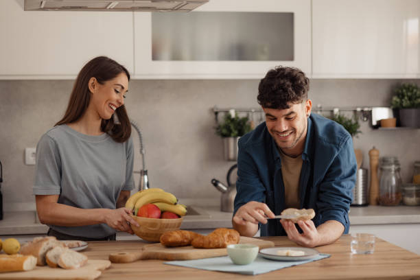 istock Happy couple enjoying in breakfast time at the kitchen. 2187944664