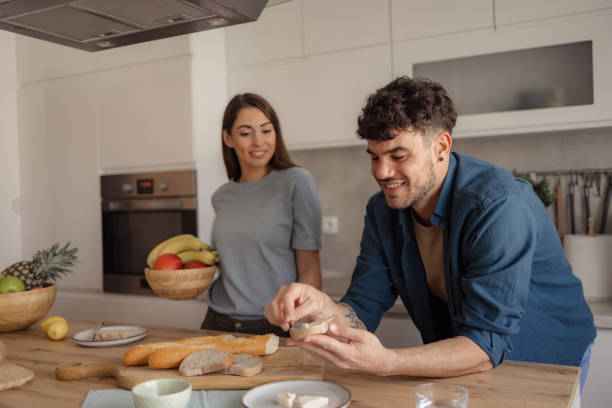 istock Young happy couple having breakfast in the kitchen. 2187944695