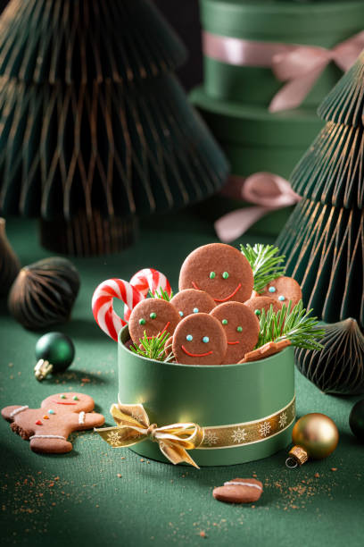 istock Sweet Christmas gingerbread mans in bottle green present box. 2187945314