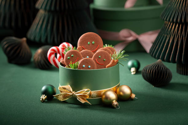 istock Tasty Christmas gingerbread mans in bottle green present box. 2187945508