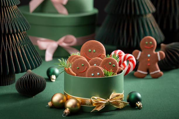 istock Sweet Christmas gingerbread mans in bottle green gift box. 2187945705