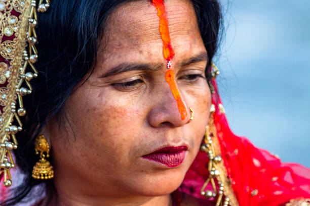 A devotee offers prayers to the setting sun during the 'Chhath' festival at the Bagmati River in Kathmandu, Nepal, on Thursday November 07, 2024.