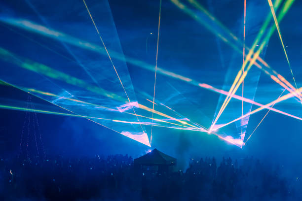 Silhouettes of audience enjoying  a rock show with blue lighting in a lively atmosphere.