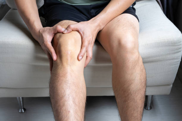 istock Knee pain man He puts his hands on his knees, pain points from osteoarthritis and bone diseases, medical concepts and treatments. 2187956302