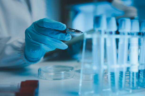 istock a chemist examines a sample of a liquid in a laboratory, a laboratory filled with scientific experiment equipment, microscope, female scientist, female chemist, researcher is searching for scientific 2187961996