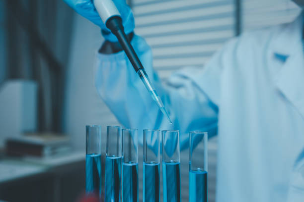 istock a chemist examines a sample of a liquid in a laboratory, a laboratory filled with scientific experiment equipment, microscope, female scientist, female chemist, researcher is searching for scientific 2187962012