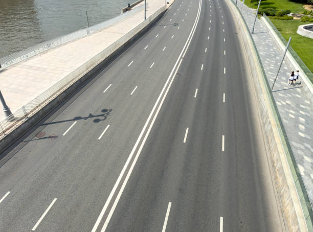 A long, empty highway with no cars on it. The road is wide and straight, with no traffic in sight