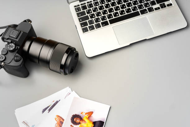 Laptop and camera on the table close up. Printing photos