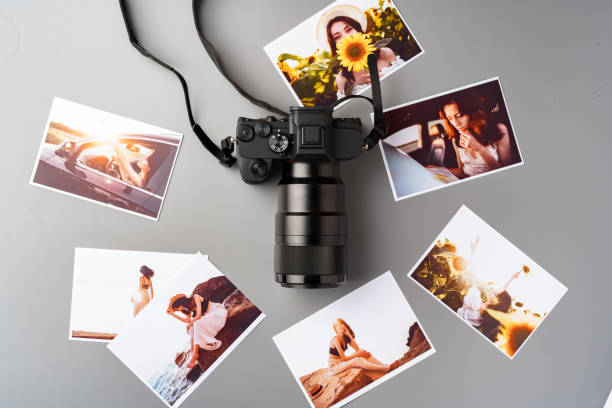 istock Photo camera with colorful printer photos on gray desk 2187967231