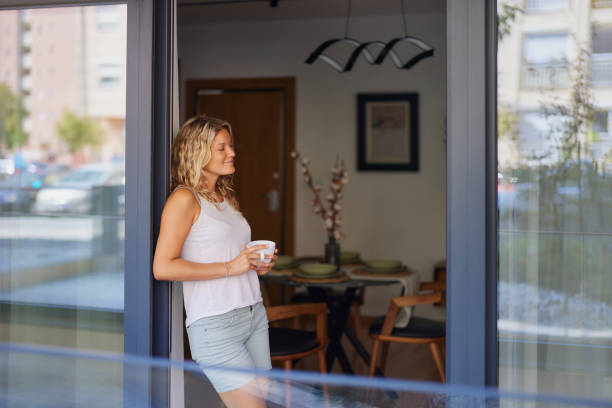 Smiling woman enjoying during coffee time on a patio.