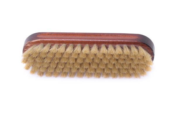 Wooden shoe shine polish brush over white background