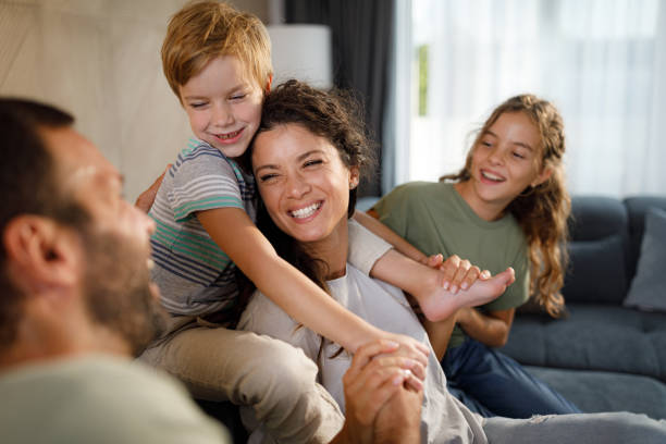 istock Cheerful family having fun while talking at home. 2187968525