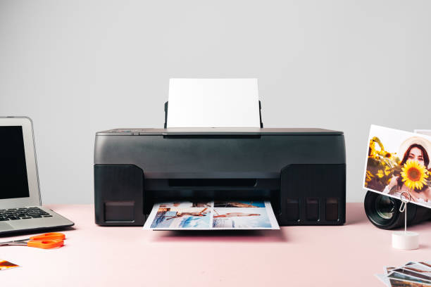 istock Printer, laptop and camera on table close up. Printing photos 2187968759