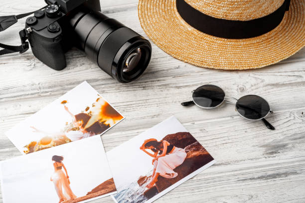 istock Photo camera with colorful printer photos on gray desk 2187970345