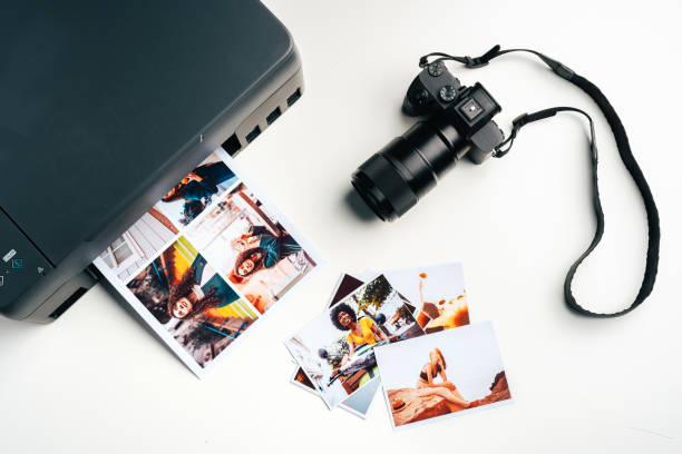 istock Printer and photo camera on table. Printing photos concept 2187970758