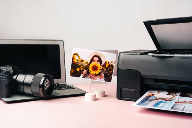 istock Printer, laptop and camera on table close up. Printing photos 2187972096