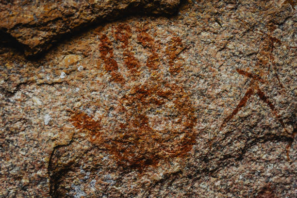 Stenciled hand rock art in red ochre at Mampoga, Arguni Island, West Papua, Indonesia.