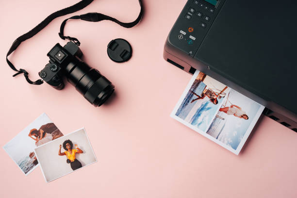 istock Printer and photo camera on table. Printing photos concept 2187973735