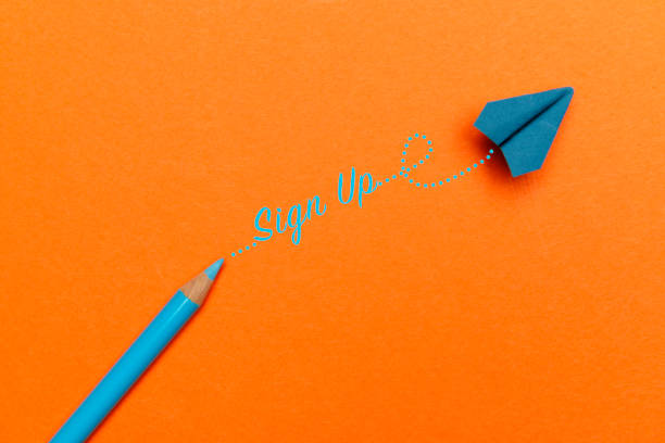 istock Blue Pencil and Origami Plane on Orange Background 2187975186