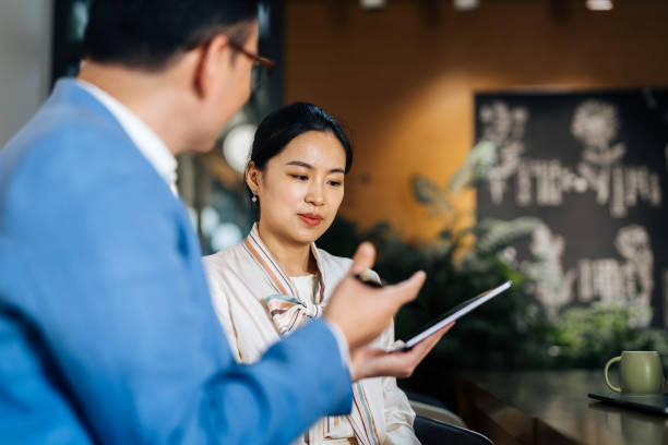 istock Asian business colleagues discussing documents on digital tebalet in a modern office. 2187976070