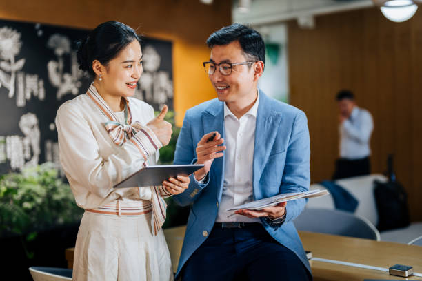 istock Asian business partners working on a digital tablet and laptop computer in the office. 2187976120
