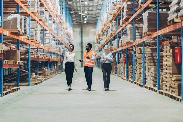 istock Group of people walking and talking in a large warehouse 2187977658