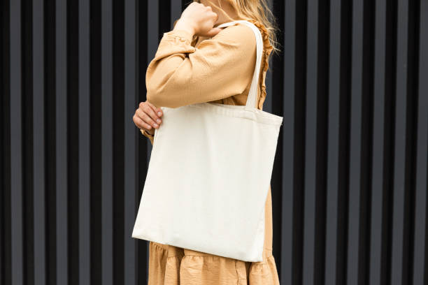 istock A girl in a summer outfit with a reusable shopping bag. 2187980098