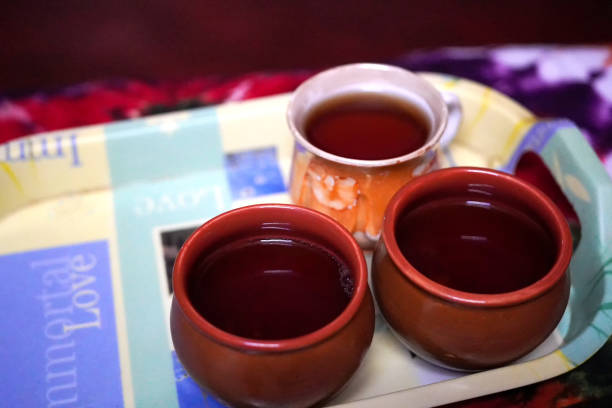 Many cups of black tea isolated on black background. Selective focus on tea.