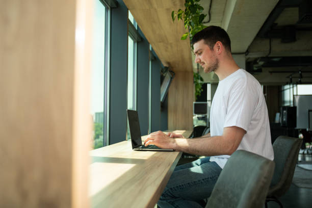 istock A cheerful young entrepreneur works in a modern workspace 2187982632