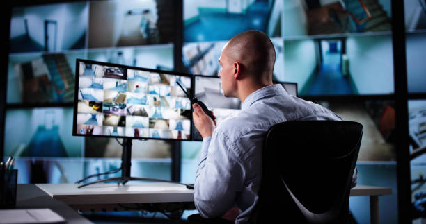 istock Security System Cctv Monitor Room. Man Using Walkie Talkie 2187983203