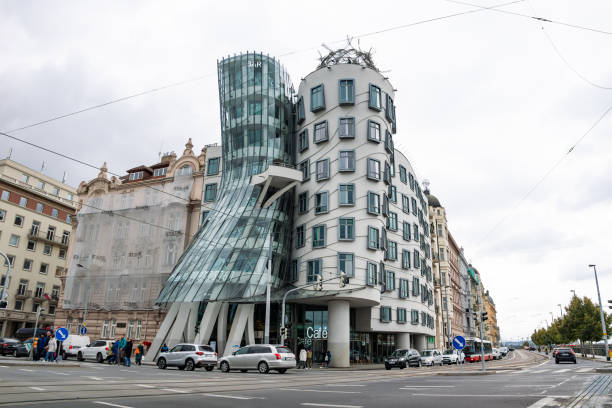 Prague, The Dancing House (Tančící dům) or Ginger and Fred building exterior in the city of Praha. Architecture during daytime at a busy road intersection.