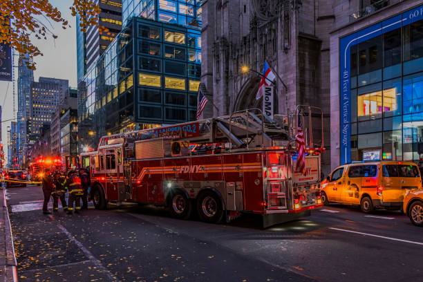 New York, United States – November 29, 2024: Firefighters stand by a firetruck on Fifth Avenue in New York City during early evening.