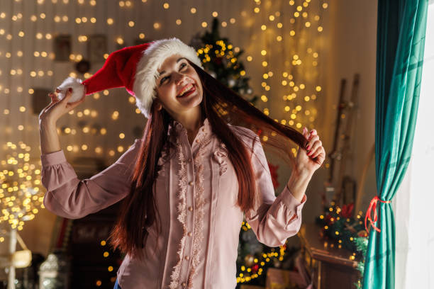 istock Charming young woman wearing a Santa hat 2187984739