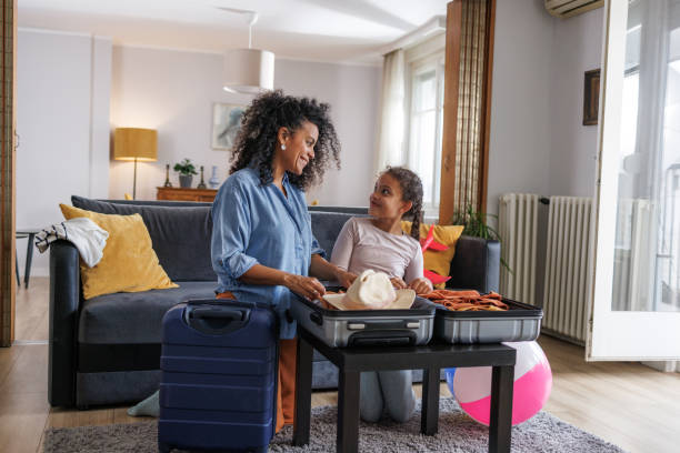 istock Mother and daughter packing for summer holidays 2187986401