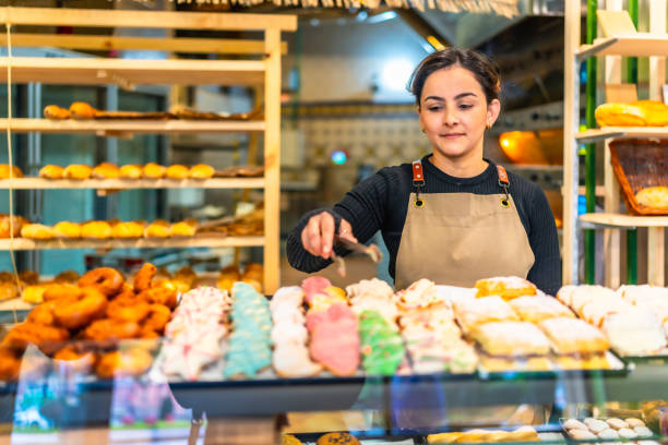istock Woman selling artisan pastries in a bakery 2187987045