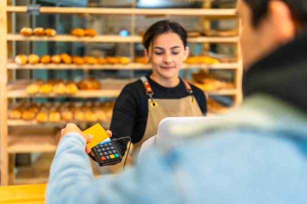 istock Man paying with credit card in a bakery 2187987089