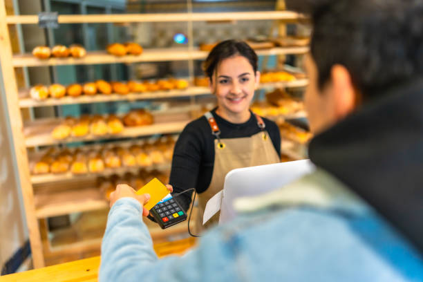istock Man paying using credit card in a bakery shop 2187987091