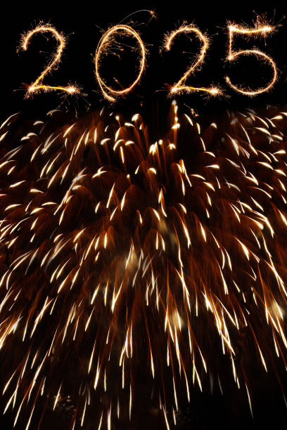 New year 2025 fireworks display in night sky, bengal sparkles illumination background.