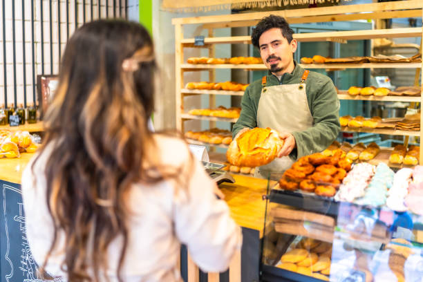 istock Woman buying artisan bread in a bakery 2187987116