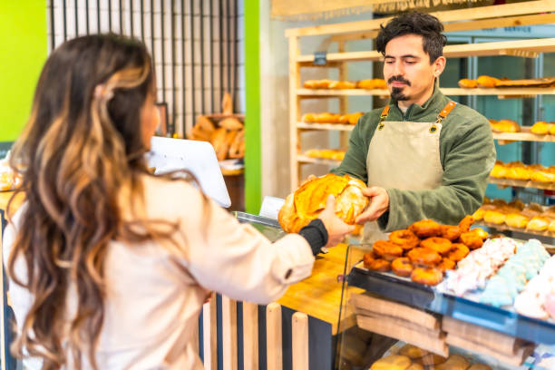 istock Woman buying artisan bread in a modern bakery 2187987127