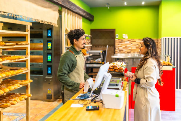 istock Woman talking to salesman in a bakery 2187987130