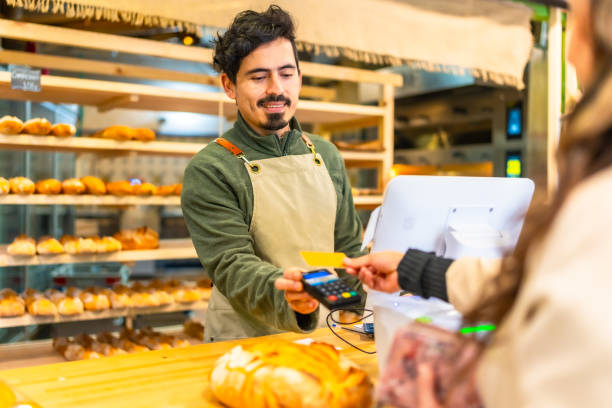 istock Woman paying using credit card in a bakery 2187987152