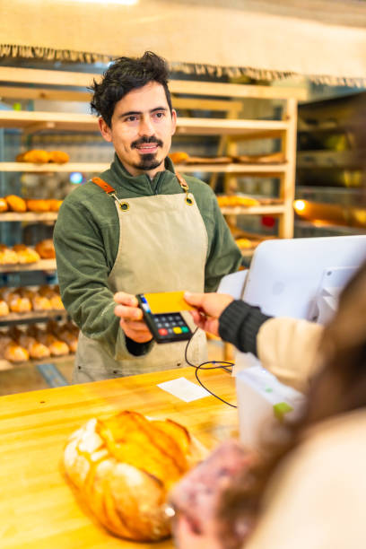istock Client paying with credit card in a bakery 2187987154